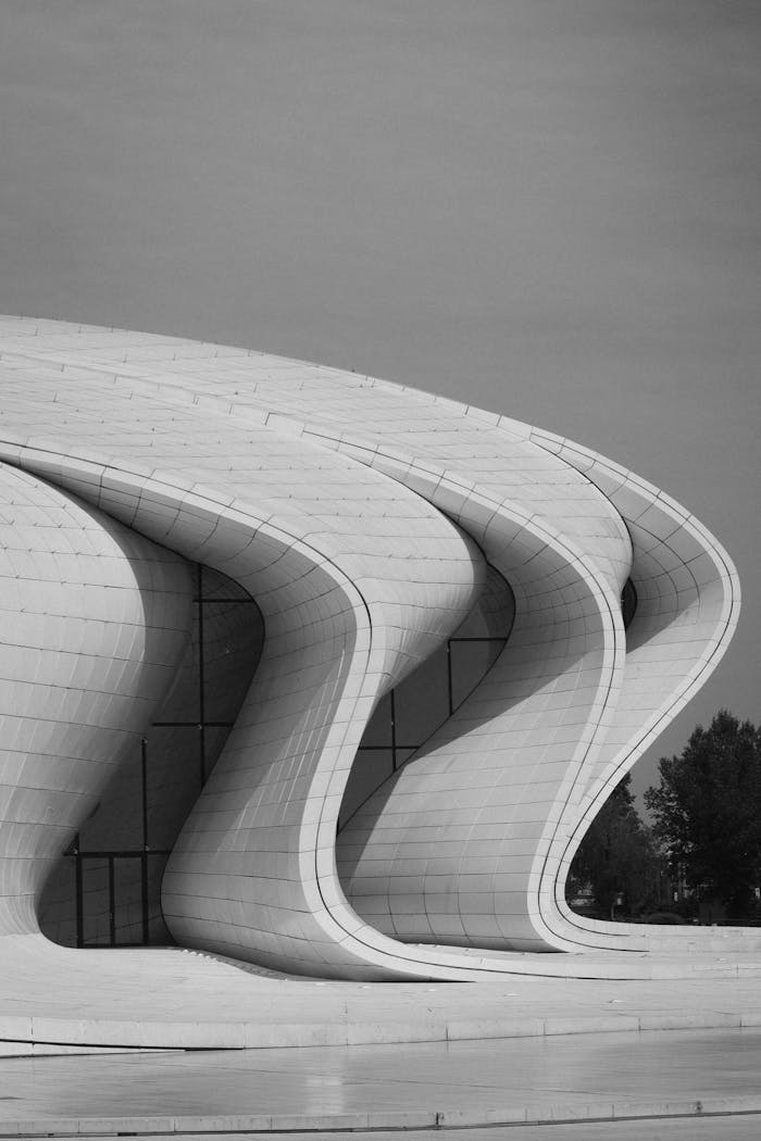 A stunning black and white capture of the modern Heydar Aliyev Centre facade.